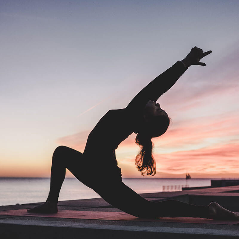 Frau macht Yoga Übungen am Wasser in der Schweiz